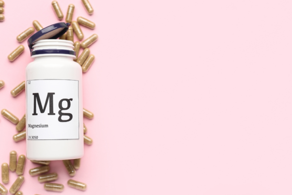 magnesium bottle with pills around it